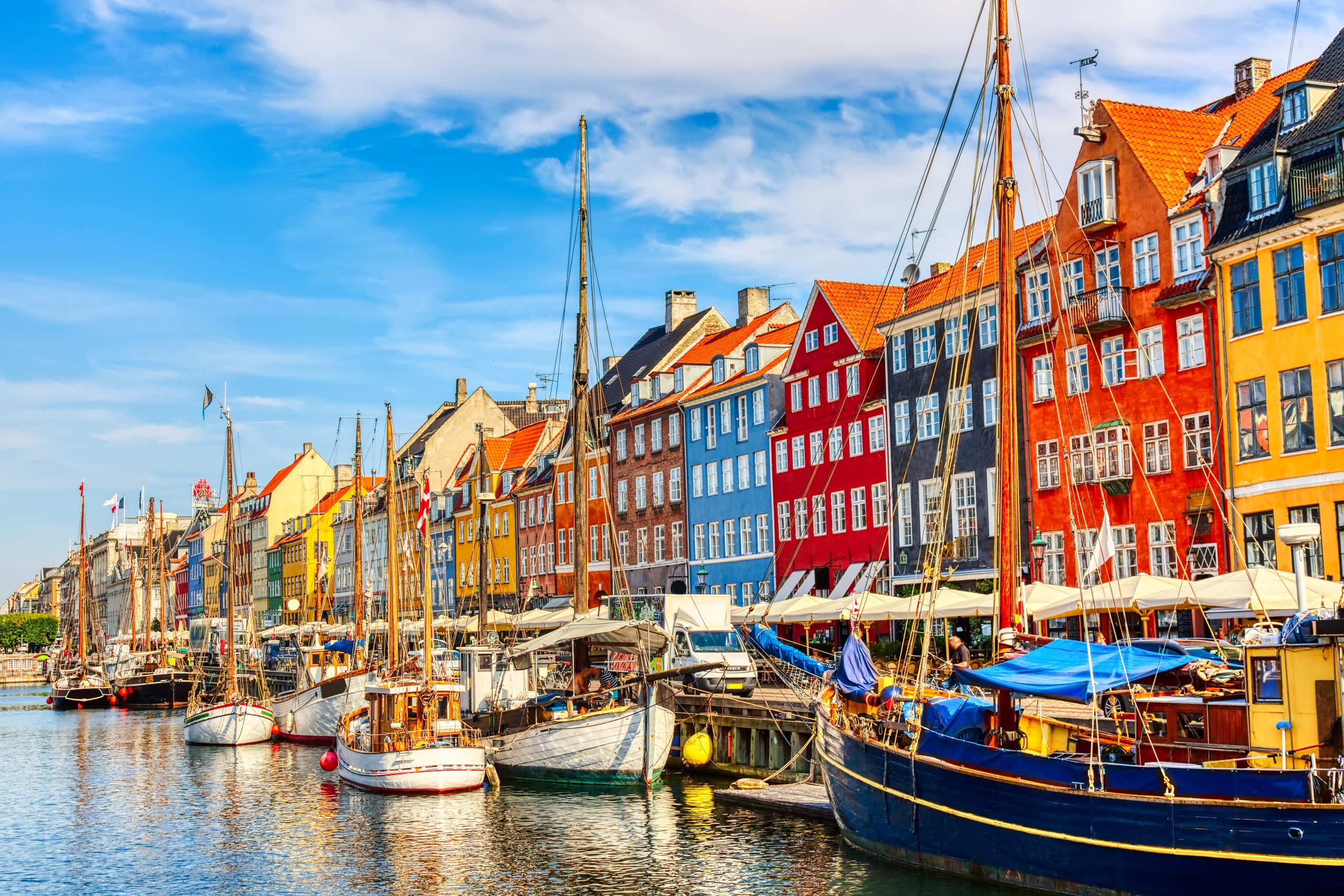 Famous old Nyhavn port in the center of Copenhagen, Denmark during summer sunny day. Copenhagen is one of the cheapest places to fly to from the UK.